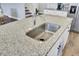 Bright kitchen features white cabinets, granite countertops, stainless steel appliances and a center island at 203 Hayworth Rd, Summerville, SC 29486