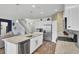Bright kitchen features white cabinets, granite countertops, stainless steel appliances and a spacious center island with seating at 203 Hayworth Rd, Summerville, SC 29486