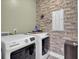 Spacious laundry room with brick accent wall and large Maytag washer and dryer at 203 Hayworth Rd, Summerville, SC 29486