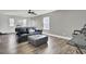 Cozy living room featuring a plush sofa, ottoman, ceiling fan and hardwood flooring at 203 Hayworth Rd, Summerville, SC 29486