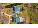 Aerial shot showcases a well-maintained home with a pool, detached garage, and meticulously landscaped surroundings at 212 Chester Ln, Cottageville, SC 29435