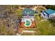 An overhead shot showcases a house with a uniquely shaped pool and meticulously maintained outdoor spaces at 212 Chester Ln, Cottageville, SC 29435