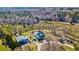 Aerial view of a private home with a spacious yard, pool, outbuildings, and wooded surroundings at 212 Chester Ln, Cottageville, SC 29435