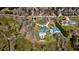 Aerial view of a house with a pool, manicured grounds, and an adjacent outbuilding in a wooded area at 212 Chester Ln, Cottageville, SC 29435