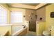 Well-lit bathroom featuring a tiled shower with glass door and a separate soaking tub at 212 Chester Ln, Cottageville, SC 29435