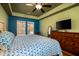 Bedroom featuring a calming blue accent wall, neutral paint, large windows and a ceiling fan at 212 Chester Ln, Cottageville, SC 29435