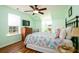 Bedroom with colorful quilt, wood laminate floor, and ceiling fan at 212 Chester Ln, Cottageville, SC 29435