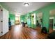 Bright bonus room featuring hardwood floors, a large mirror, seating area, and ample natural light at 212 Chester Ln, Cottageville, SC 29435