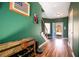 Inviting entryway features hardwood floors, a staircase, and a charming wine rack for convenient storage and stylish decor at 212 Chester Ln, Cottageville, SC 29435