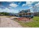 Charming home featuring a wraparound porch and detached garage, complemented by a spacious yard and gravel driveway at 212 Chester Ln, Cottageville, SC 29435