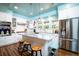 Modern kitchen with stainless steel appliances, a marble countertop island with seating, and a stylish backsplash at 212 Chester Ln, Cottageville, SC 29435