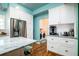 Bright kitchen with stainless steel appliances, white cabinetry, and an adjacent laundry room for added convenience at 212 Chester Ln, Cottageville, SC 29435
