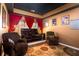 Inviting living room with a cozy seating arrangement, dark blue ceiling, and a movie-viewing theme at 212 Chester Ln, Cottageville, SC 29435