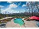 Backyard pool area surrounded by a patio, landscaping, and partial shade at 212 Chester Ln, Cottageville, SC 29435