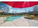 Backyard pool area surrounded by lush landscaping, shaded by umbrellas at 212 Chester Ln, Cottageville, SC 29435