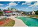 Refreshing pool area with lounge seating, landscaped yard, and a partial view of the house at 212 Chester Ln, Cottageville, SC 29435