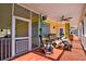 Screened porch featuring cozy seating, a ceiling fan, and access to the backyard provides a relaxing space at 212 Chester Ln, Cottageville, SC 29435