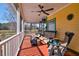 Relaxing screened porch features comfortable seating, a ceiling fan, and an open view of the surrounding landscape at 212 Chester Ln, Cottageville, SC 29435