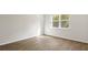 Bright bedroom with hardwood floors, white trim, a large window, and ample natural light at 2196 Macallan Blvd, Ravenel, SC 29470