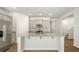 Spacious kitchen with an island, gray cabinets, stainless steel appliances, and wood flooring at 2196 Macallan Blvd, Ravenel, SC 29470