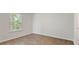 Bright bedroom with light-filled window offering natural light and wood-look flooring at 2250 Macallan Blvd, Ravenel, SC 29470
