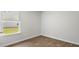 Bright bedroom with laminate floors, neutral walls, and a window with blinds overlooking a lawn at 2250 Macallan Blvd, Ravenel, SC 29470