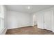 A cozy bedroom with light-filled windows, wood-look flooring, and a convenient door to a private bathroom at 2250 Macallan Blvd, Ravenel, SC 29470