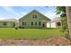 View of home's backyard featuring a covered patio, lush green lawn, and side exterior at 2275 Macallan Blvd, Ravenel, SC 29470