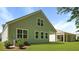 View of home's backyard featuring a covered patio, lush green lawn, and side exterior at 2275 Macallan Blvd, Ravenel, SC 29470