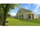 View of home's backyard featuring a covered patio, lush green lawn, and side exterior at 2275 Macallan Blvd, Ravenel, SC 29470
