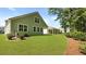 View of home's backyard featuring a covered patio, lush green lawn, and side exterior at 2275 Macallan Blvd, Ravenel, SC 29470