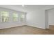 Spacious bedroom with plank flooring and three large windows for abundant natural light at 2275 Macallan Blvd, Ravenel, SC 29470