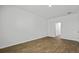 A well-lit bedroom features hardwood floors, white walls, and ample space at 2275 Macallan Blvd, Ravenel, SC 29470