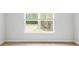 Bright, neutral bedroom with a view of a pond and trees outside the window at 2275 Macallan Blvd, Ravenel, SC 29470