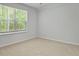 Cozy bedroom with carpeted floors and a view of the outdoors at 2275 Macallan Blvd, Ravenel, SC 29470