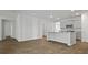 View of the open-concept kitchen with grey cabinets, an island, and modern appliances at 2275 Macallan Blvd, Ravenel, SC 29470