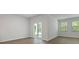 A bright living room featuring plank floors and large windows letting in natural light at 2275 Macallan Blvd, Ravenel, SC 29470