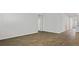 Spacious living room with wood-look plank flooring leading to the kitchen and other rooms at 2275 Macallan Blvd, Ravenel, SC 29470