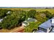 Aerial view of home surrounded by trees and marshlands at 2314 Goldbug Ave, Sullivans Island, SC 29482
