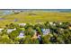 Beautiful aerial view of homes surrounded by lush greenery and a scenic marsh landscape at 2314 Goldbug Ave, Sullivans Island, SC 29482