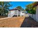 The backyard features a screened in porch, stairs, and a fence at 2314 Goldbug Ave, Sullivans Island, SC 29482
