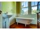 Bathroom features a vintage claw foot tub and pedestal sink at 2314 Goldbug Ave, Sullivans Island, SC 29482