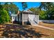 Charming single-story home with a screened-in porch and white picket fence, surrounded by lush greenery at 2314 Goldbug Ave, Sullivans Island, SC 29482