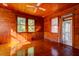 Cozy living room with hardwood floors, wood paneling and plenty of natural light at 2314 Goldbug Ave, Sullivans Island, SC 29482