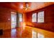 Cozy living room with hardwood floors, wood paneling and an access door to outside at 2314 Goldbug Ave, Sullivans Island, SC 29482