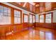 Inviting living room with hardwood floors, wood-paneled walls, and an abundance of natural light at 2314 Goldbug Ave, Sullivans Island, SC 29482