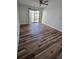 Sun-filled living room featuring new hardwood floors and sliding glass doors to outdoor patio at 2326 Treescape Dr # 2, Charleston, SC 29414