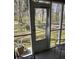 Screened porch showcases outdoor access, seating and a view of the backyard at 2326 Treescape Dr # 2, Charleston, SC 29414