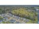 High angle aerial view of homes surrounded by green trees with a glimpse of a lake in the distance at 236 Emerald Isle Dr, Moncks Corner, SC 29461