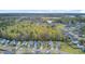 High angle aerial view showcases a residential area bordered by lush green trees and a glimpse of a lake at 236 Emerald Isle Dr, Moncks Corner, SC 29461